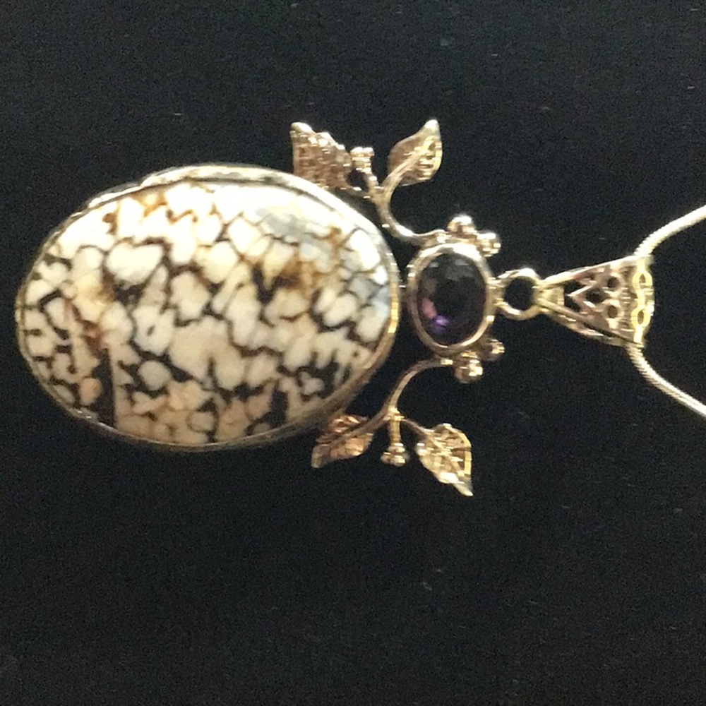 2inch with small purple stone.  This is a natural stone.